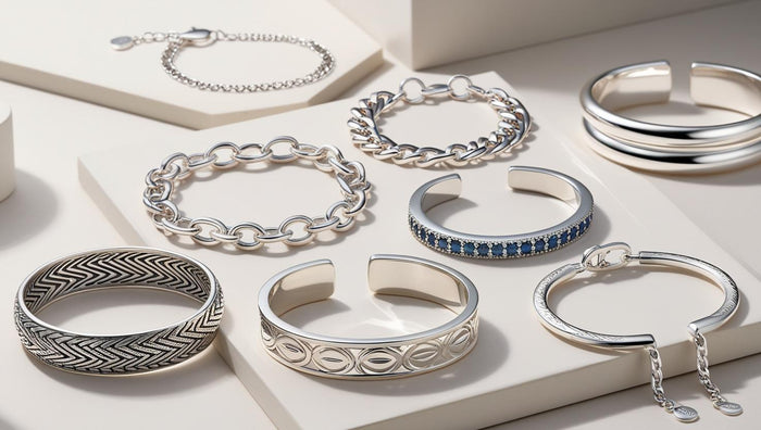 Elegant silver bracelets with unique patterns and gemstones displayed on minimal white platforms, perfect for different occasions and styles.