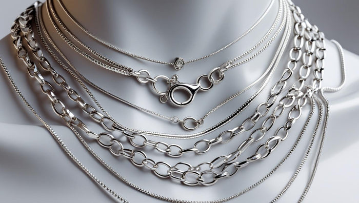 Mannequin displaying layered sterling silver necklaces in assorted chain styles, highlighting the shine and detail of each design.