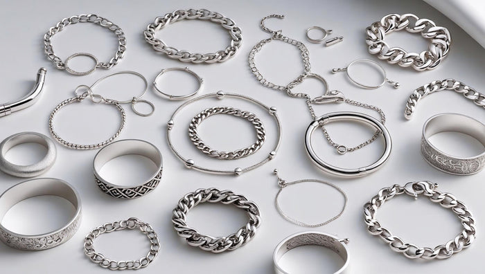 Assorted Silver Bracelets in various styles laid out on a white surface for a flat-lay display.