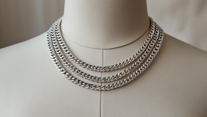 Three thick silver chains displayed on a mannequin, illustrating bold and structured jewelry layering.