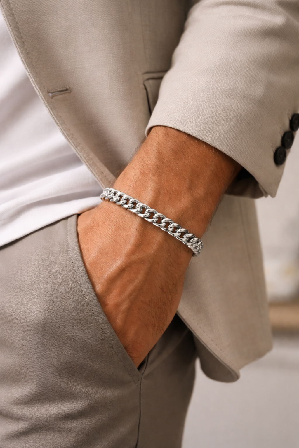 Person wearing Teddy Howler hollow curb bracelet on a blurred background